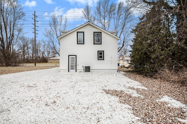 snow covered back of property with central air condition unit