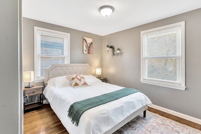 bedroom with hardwood / wood-style flooring