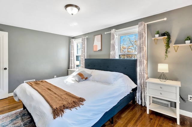 bedroom with dark wood-type flooring