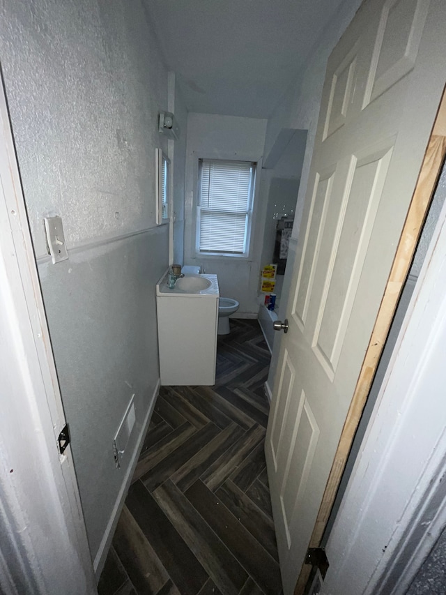 stairway featuring parquet floors and sink