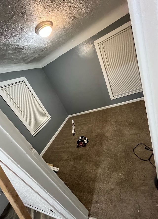 interior space with lofted ceiling and a textured ceiling