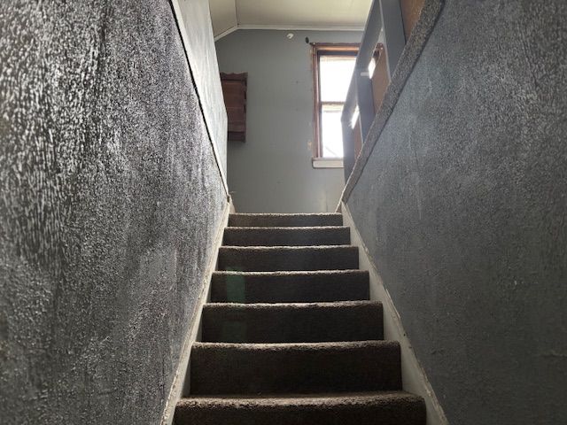 stairway featuring lofted ceiling
