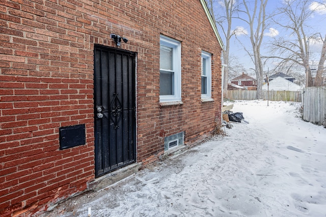 view of snow covered property entrance