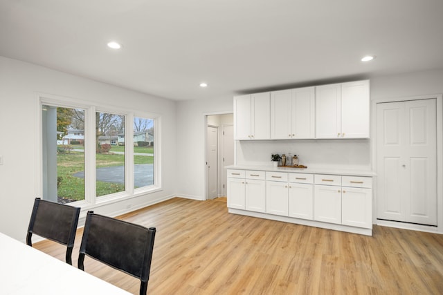 kitchen featuring white cabinets, a wealth of natural light, and light hardwood / wood-style floors