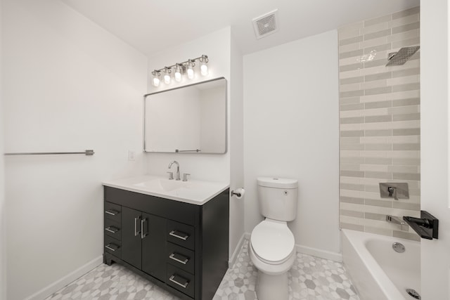 full bathroom featuring toilet, vanity, and tiled shower / bath