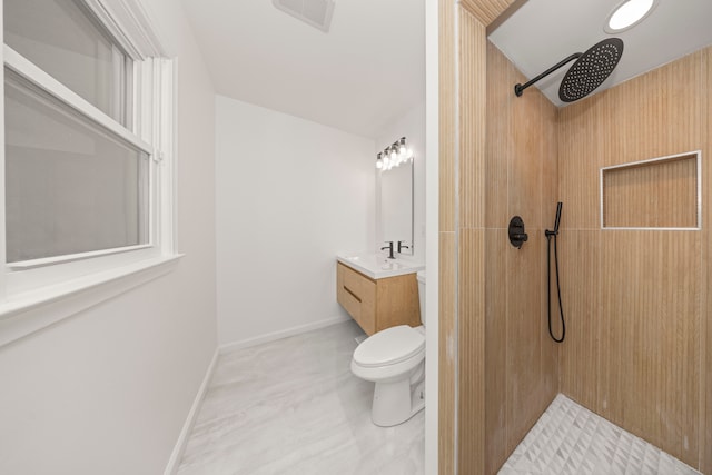 bathroom with walk in shower, vanity, and toilet