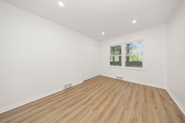 spare room with light hardwood / wood-style floors