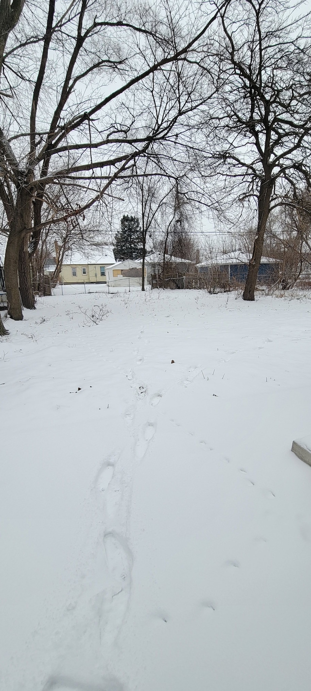 yard covered in snow with a garage