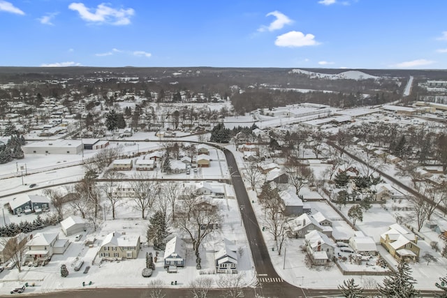 snowy aerial view with a residential view