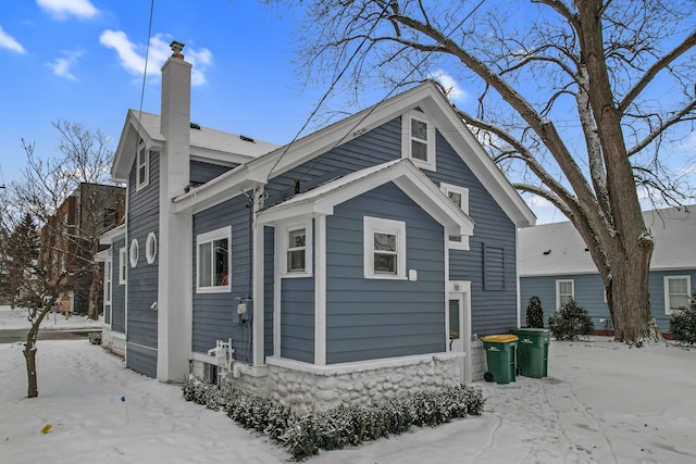 view of snow covered rear of property