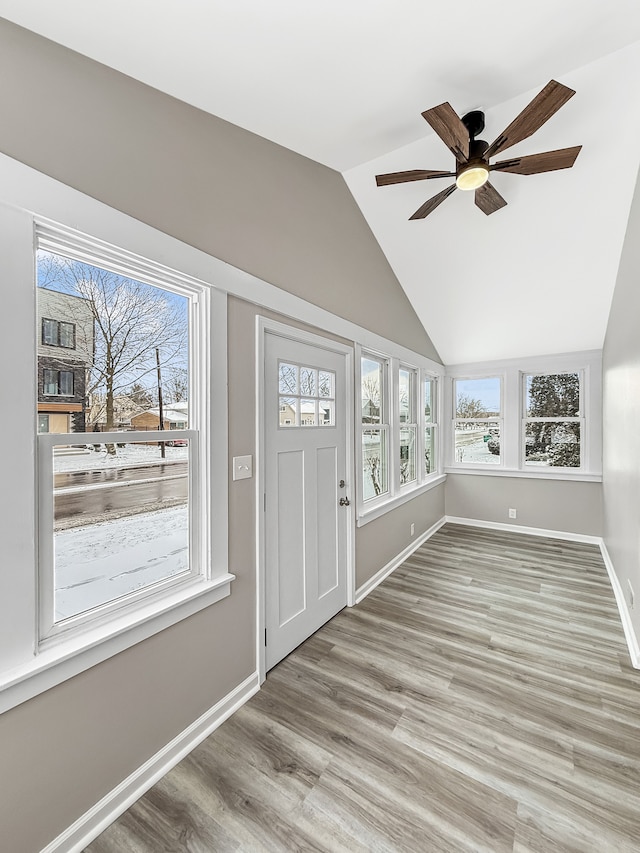 foyer entrance with ceiling fan, light hardwood / wood-style floors, and lofted ceiling