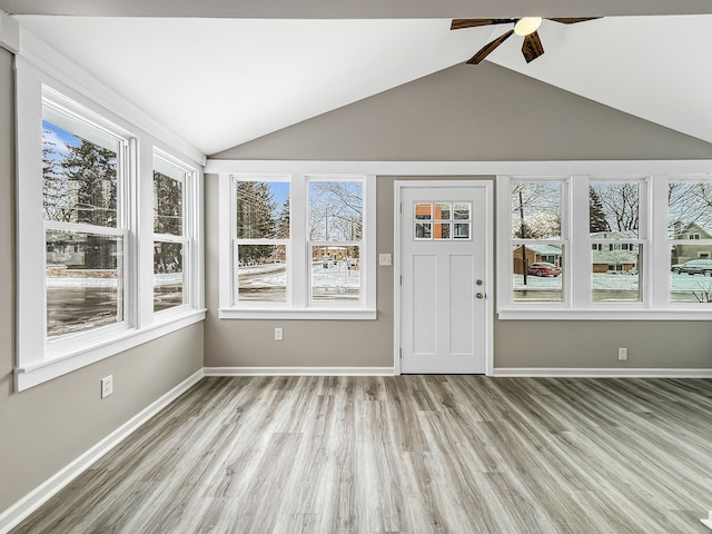 unfurnished sunroom with vaulted ceiling and ceiling fan