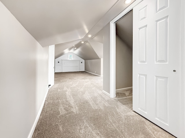 bonus room featuring vaulted ceiling, carpet, and baseboards