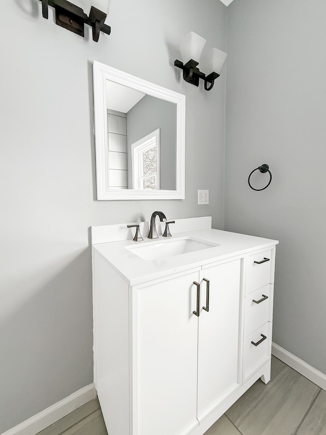 bathroom with vanity and baseboards