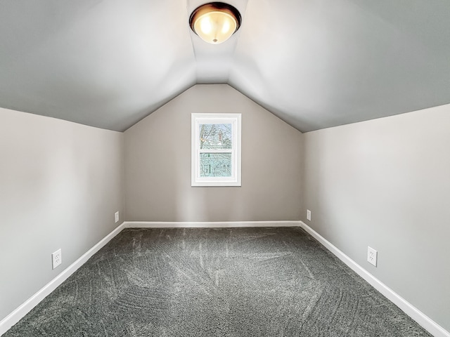 additional living space featuring lofted ceiling, carpet, and baseboards