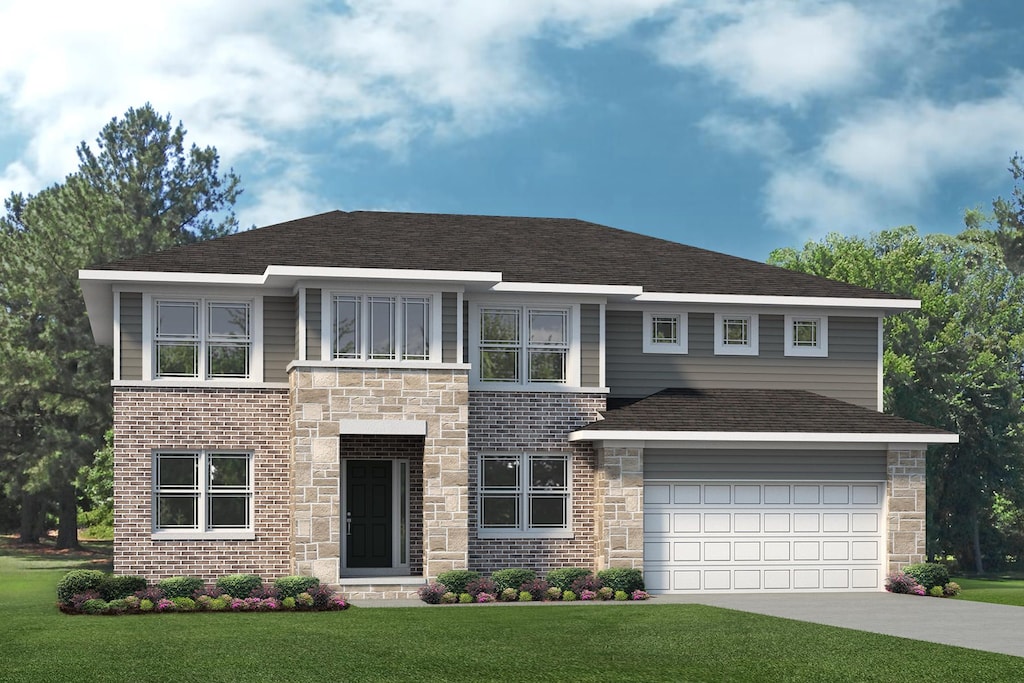 view of front of home with a garage and a front lawn