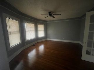 empty room featuring hardwood / wood-style floors and ceiling fan