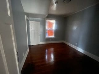 empty room featuring dark hardwood / wood-style flooring