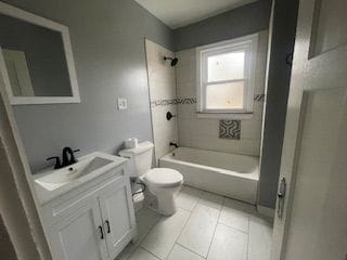 full bathroom with vanity, toilet, tiled shower / bath combo, and tile patterned flooring