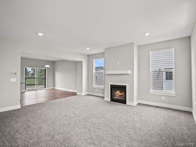 unfurnished living room with carpet floors