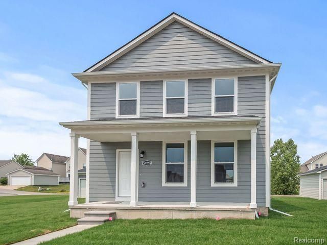 view of front of property with a porch and a front yard