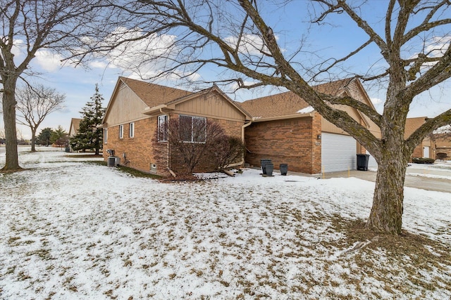 view of front of home featuring a garage and central AC