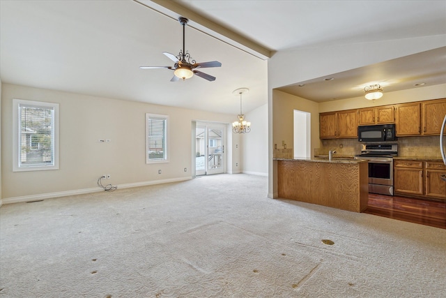 kitchen featuring kitchen peninsula, stainless steel electric stove, plenty of natural light, and tasteful backsplash