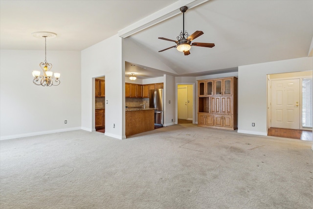 unfurnished living room with ceiling fan with notable chandelier, light colored carpet, and lofted ceiling