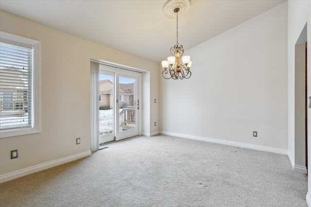 unfurnished room with a notable chandelier, carpet, and lofted ceiling