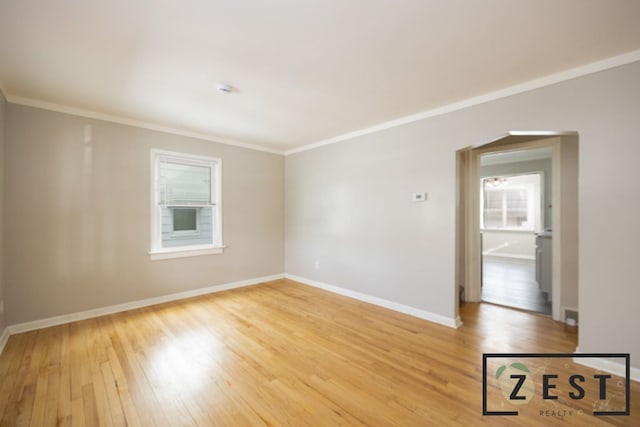 unfurnished room featuring ornamental molding and wood-type flooring