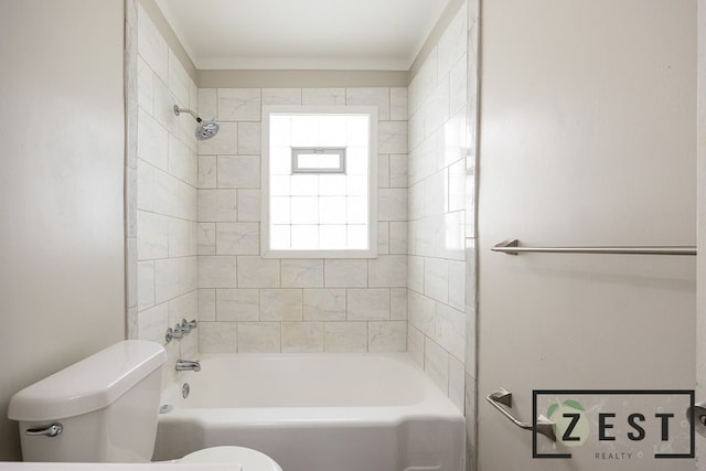 bathroom featuring tiled shower / bath and toilet