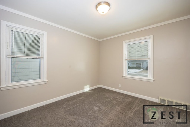 unfurnished room featuring ornamental molding and dark colored carpet