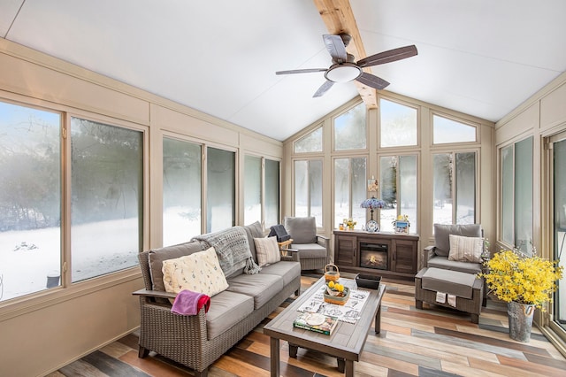 sunroom featuring ceiling fan and lofted ceiling