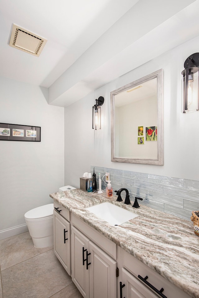 bathroom featuring decorative backsplash, tile patterned floors, vanity, and toilet