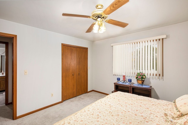 bedroom featuring light carpet, a closet, and ceiling fan