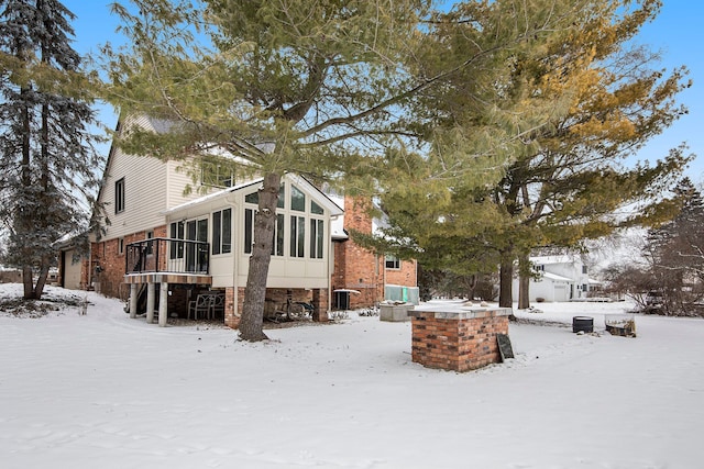 exterior space with a sunroom and cooling unit