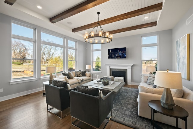 living room with wooden ceiling, an inviting chandelier, beam ceiling, and dark hardwood / wood-style flooring