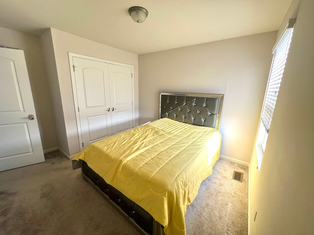 carpeted bedroom with a closet