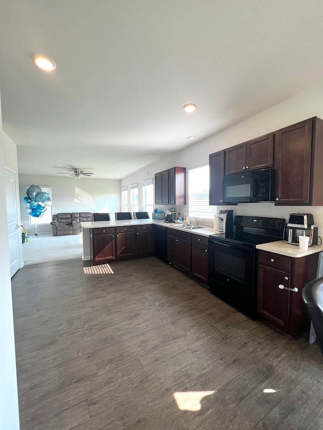 kitchen featuring sink, black appliances, ceiling fan, and dark hardwood / wood-style flooring