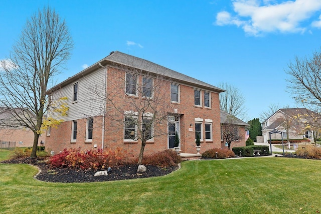 colonial-style house featuring a front yard