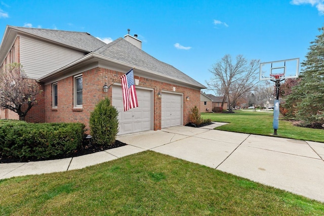 view of side of property with a garage and a lawn