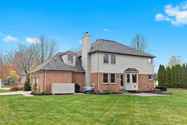 rear view of house with a yard