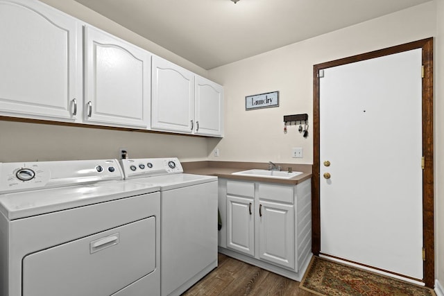 washroom with cabinets, sink, dark wood-type flooring, and washer and clothes dryer