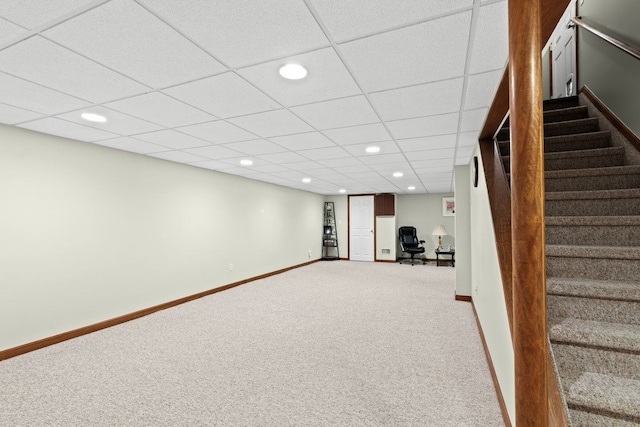 basement featuring carpet and a drop ceiling