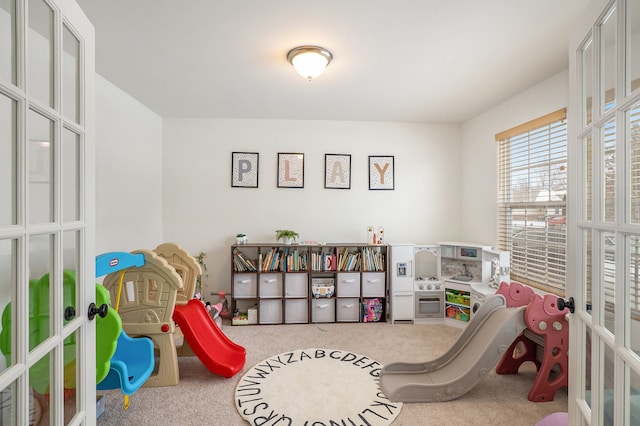 rec room featuring french doors and carpet flooring