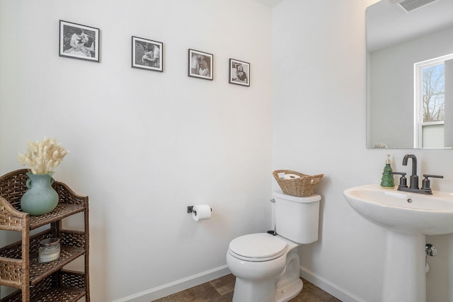 bathroom with sink, hardwood / wood-style flooring, and toilet