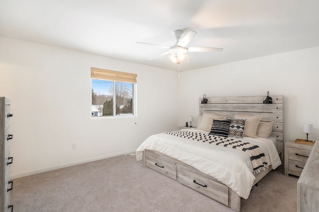 bedroom featuring light colored carpet and ceiling fan