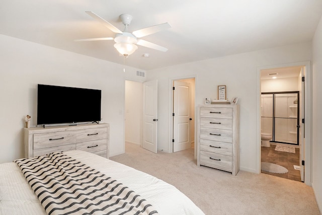 bedroom with light carpet, ceiling fan, and ensuite bathroom