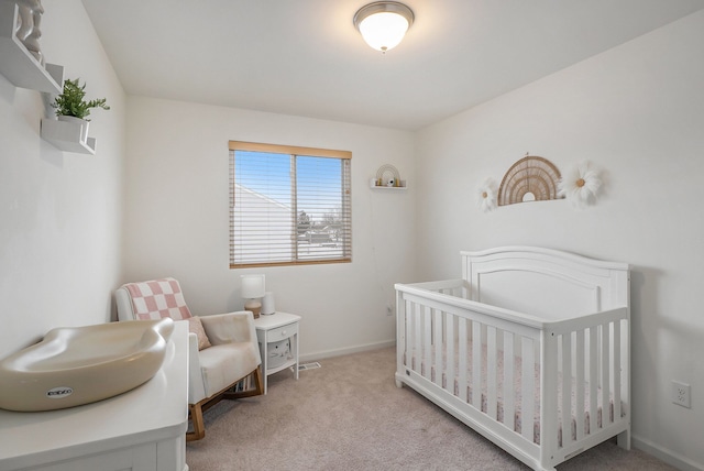 carpeted bedroom featuring a crib