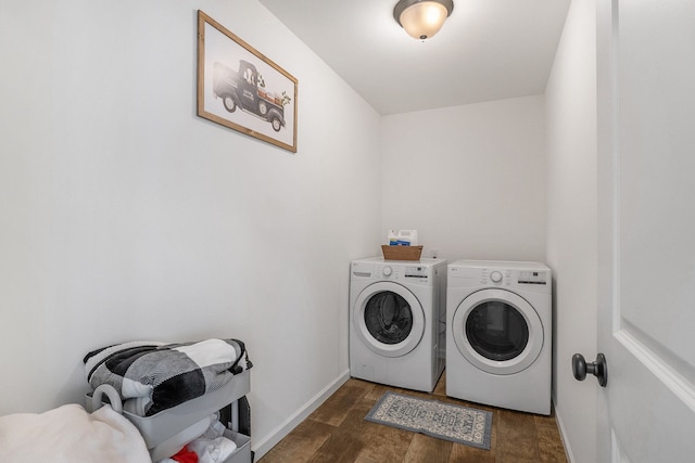 washroom with dark hardwood / wood-style floors and washing machine and dryer